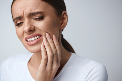 Woman with toothache in need of an emergency dentist in Little Rock, AR